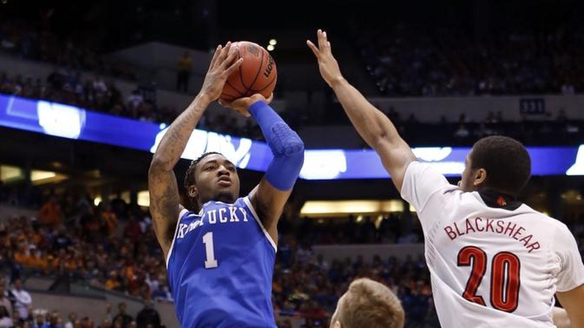 Kentucky Wildcats guard/forward James Young (1) shot against Louisville Cardinals forward Stephan Van Treese (44) and Louisville Cardinals guard/forward Wayne Blackshear (20) during an NCAA Tournament game in Indianapolis on March 28, 2014.