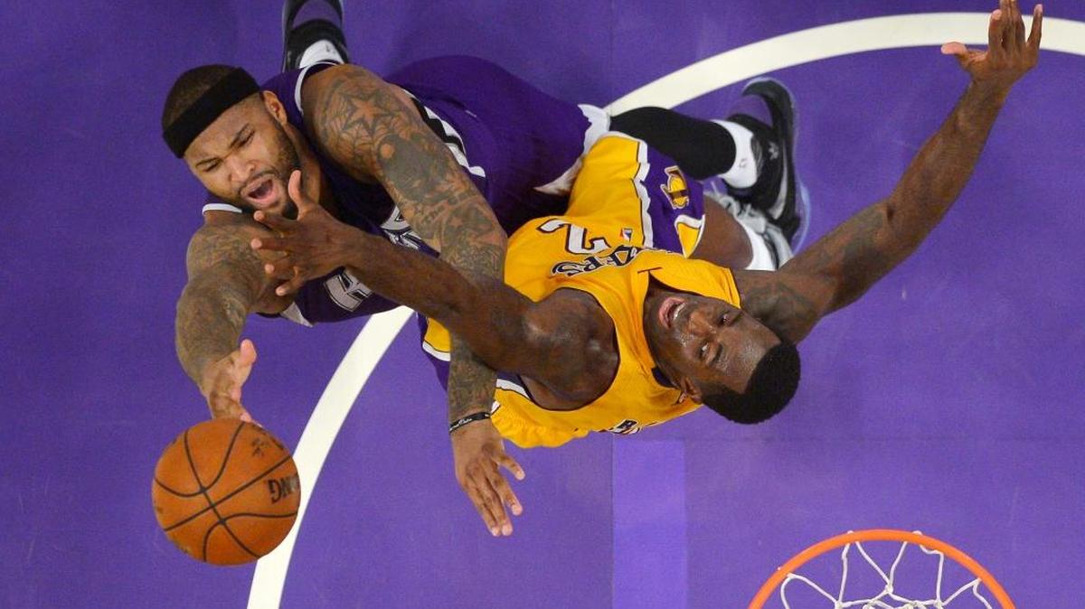 The Kings’ DeMarcus Cousins, left, shot the ball as the Lakers’ Brandon Bass defended on Jan. 20 in Los Angeles. The Kings won 112-93.