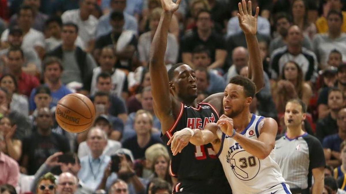 Golden State Warriors guard Stephen Curry pass the ball against Miami Heat forward Bam Adebayo during the second quarter of an NBA basketball game at the AmericanAirlines Arena in Miami on Sunday, December 3, 2017.