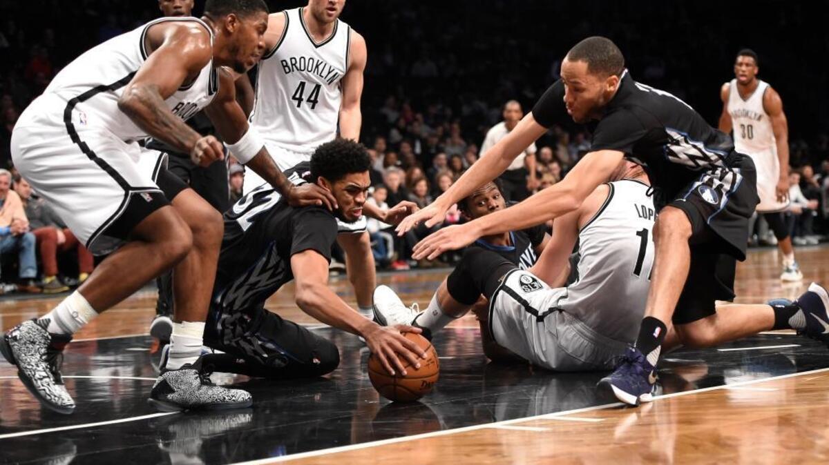 Brooklyn Nets forward Joe Johnson (7), Minnesota Timberwolves center Karl-Anthony Towns (32), Nets center Brook Lopez (11) and Timberwolves forward Tayshaun Prince (12) scramble for a loose ball during the first half of an NBA basketball game on Sunday, Dec. 20, 2015, in New York.