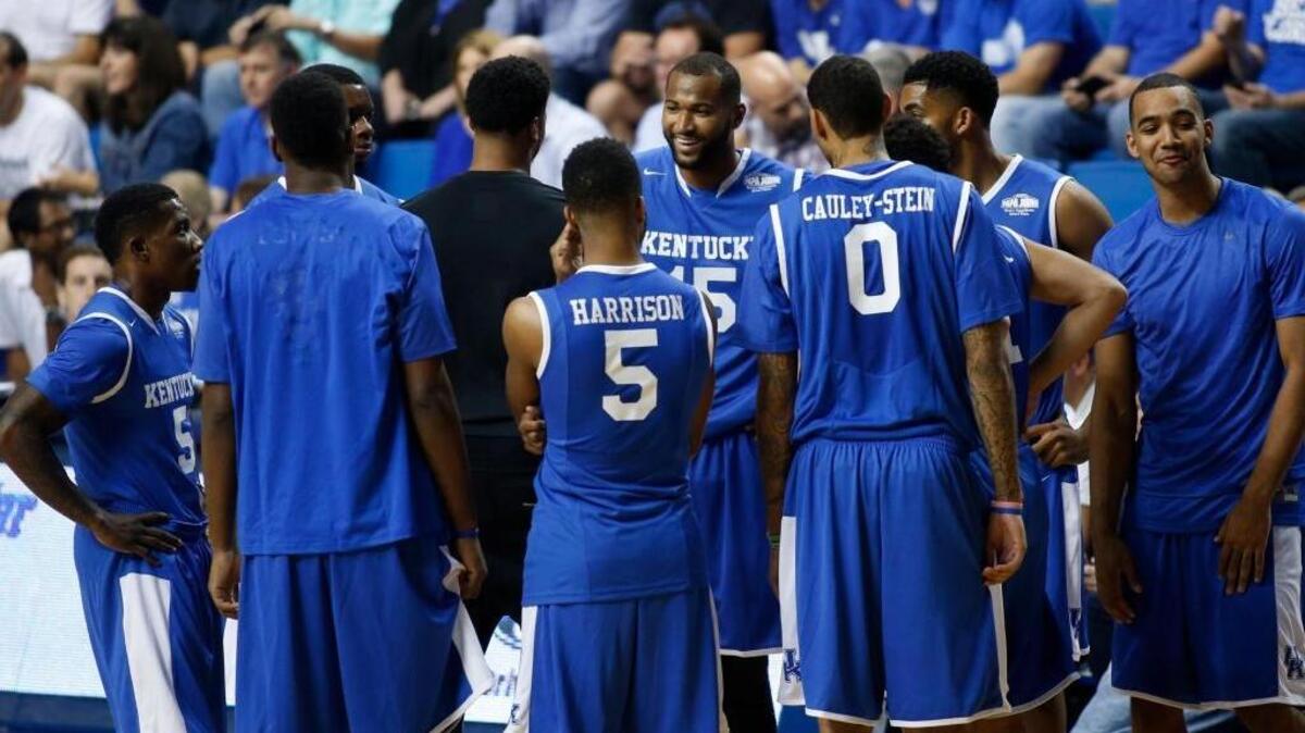 Kentucky alum DeMarcus Cousins (center) talked to his teammates, including Karl-Anthony Towns (second from right) during a timeout during the school’s charity game against North Carolina alums on Sunday, Sept. 13, 2015, in Rupp Arena in Lexington.
