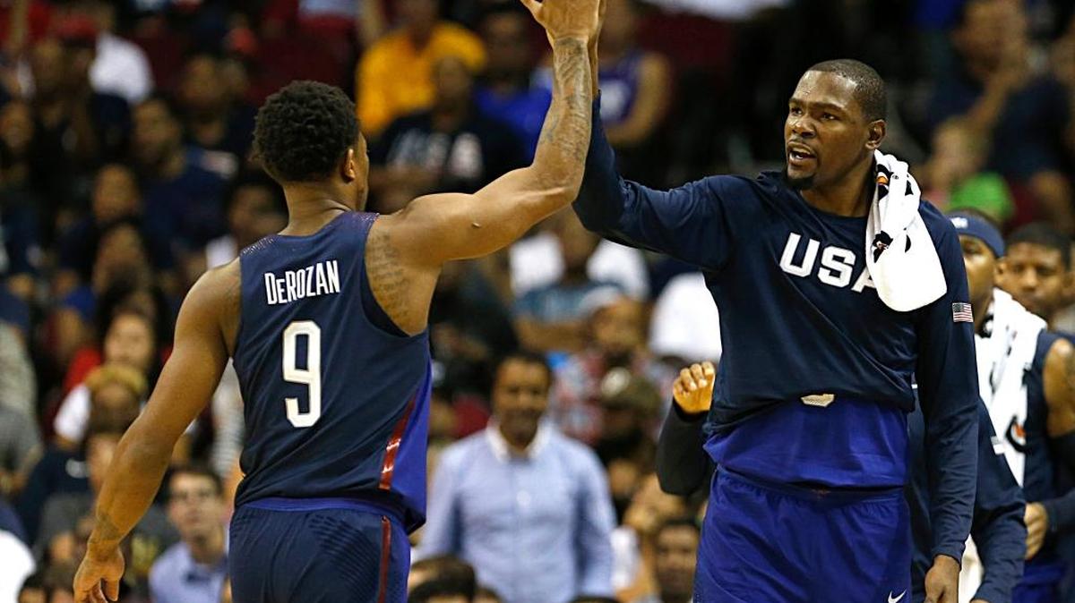 USA's Kevin Durant, right, high fives teammate DeMar DeRozan, left, during a basketball exhibition game against Nigeria, Monday, Aug. 1, 2016, in Houston. (James Nielsen/Houston Chronicle via AP)