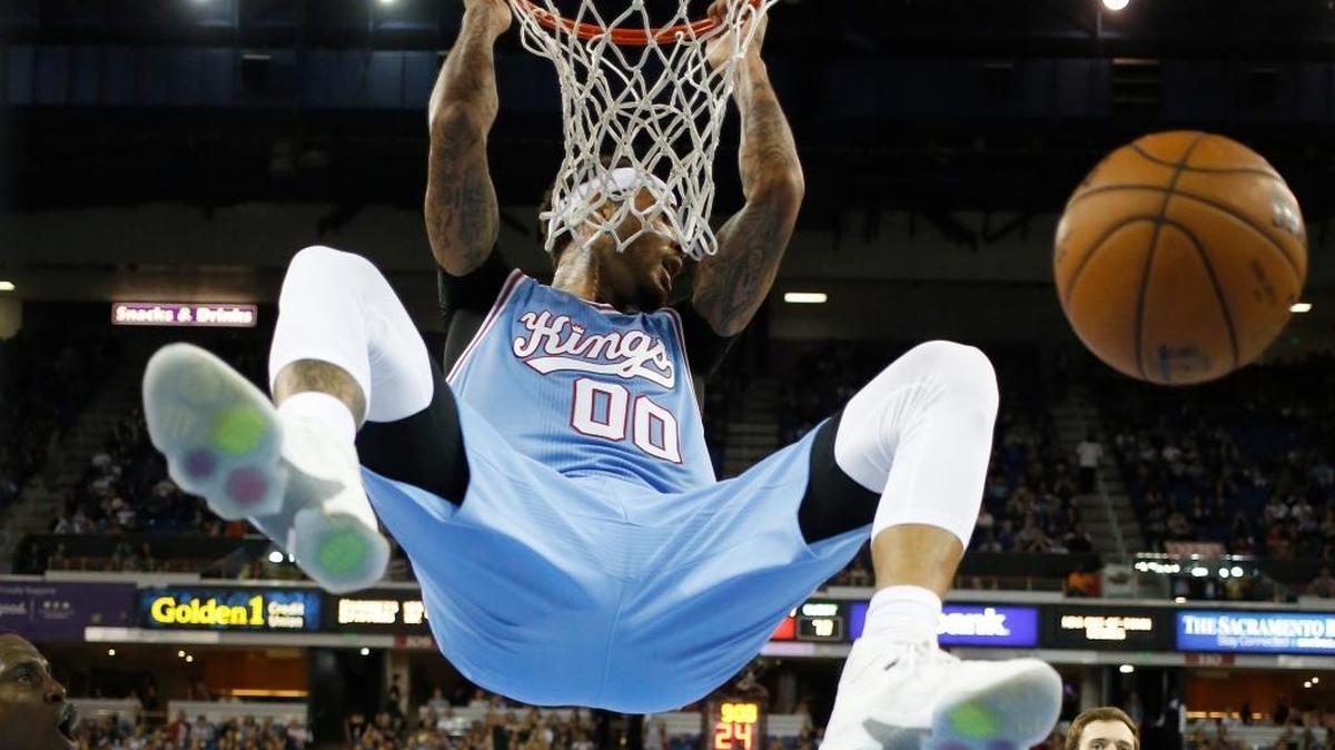 Sacramento Kings center Willie Cauley-Stein hangs from the rim after dunking against the Phoenix Suns during the second half of an NBA basketball game Friday, March 25, 2016, in Sacramento, Calif. The Kings won 116-94.