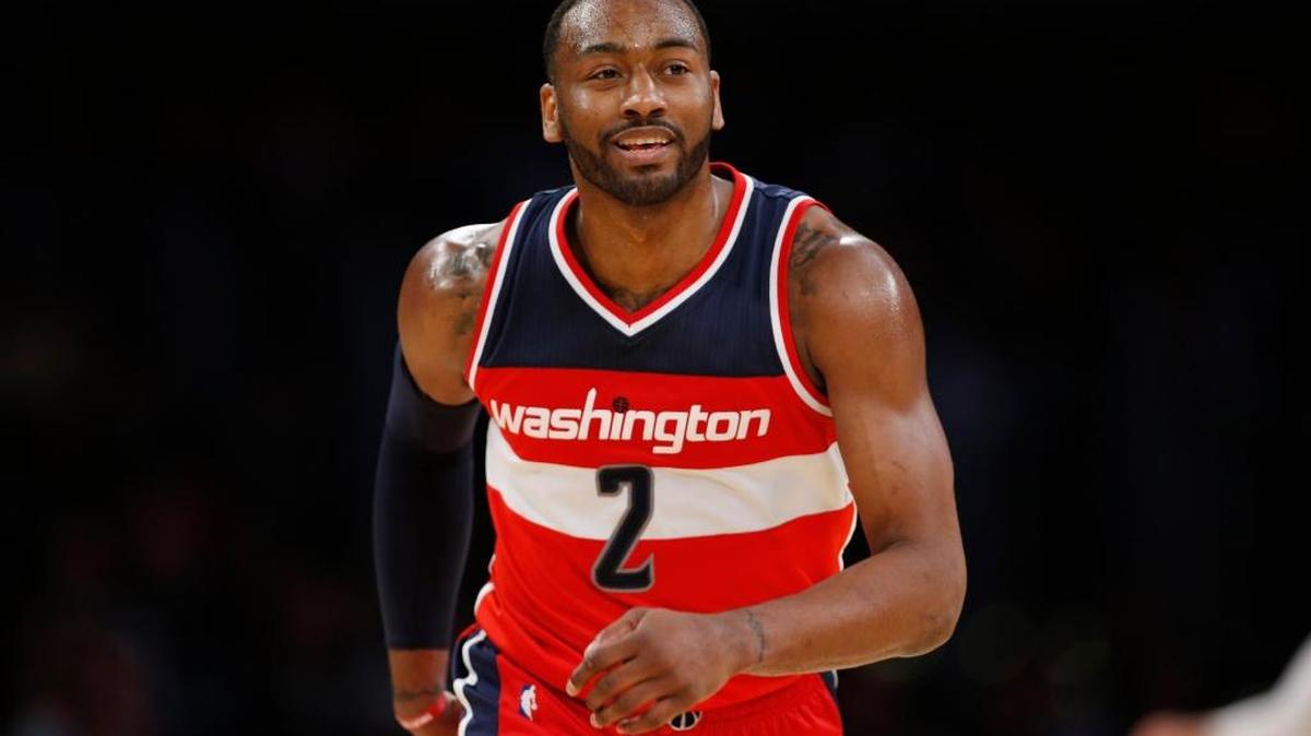 Washington Wizards guard John Wall smiles after making a shot against the Los Angeles Lakers during the second half of an NBA basketball game, Tuesday, March 28, 2017, in Los Angeles. The Wizards won 119-108.