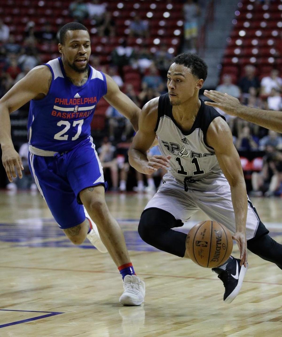 The San Antonio Spurs' Bryn Forbes drove around the Philadelphia 76ers' Isaiah Briscoe during the first half of an NBA summer league basketball game, Sunday, July 9, 2017, in Las Vegas.