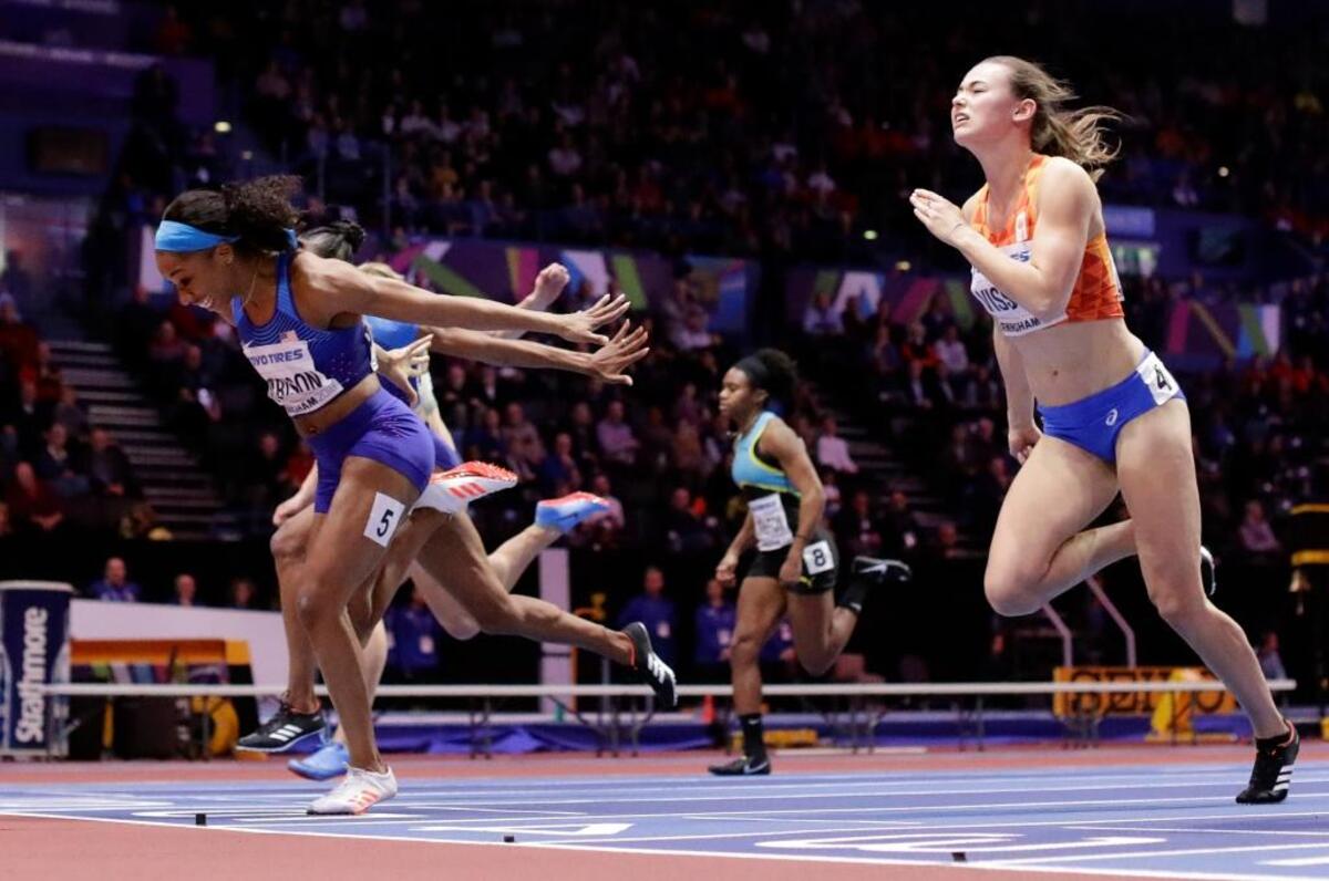 Gold medalist Kendra Harrison, left, and bronze medalist Nadine Visser, right, crossed the finish line in the women’s 60-meter hurdles at the world championships.