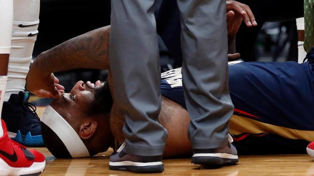 New Orleans Pelicans center DeMarcus Cousins lies on the court while being tended to after injuring his left Achilles tendon, according to the team, during the second half of an NBA basketball game against the Houston Rockets in New Orleans, Friday, Jan. 26, 2018. The Pelicans won 115-113.