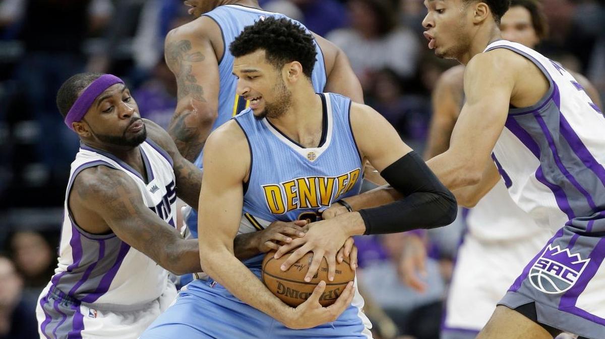 Sacramento Kings' Ty Lawson, left, and Skal Labissiere, right, double-team Denver Nuggets guard Jamal Murray during the second half of an NBA basketball game, Saturday, March 11, 2017, in Sacramento, Calif. The Nuggets won 105-92.