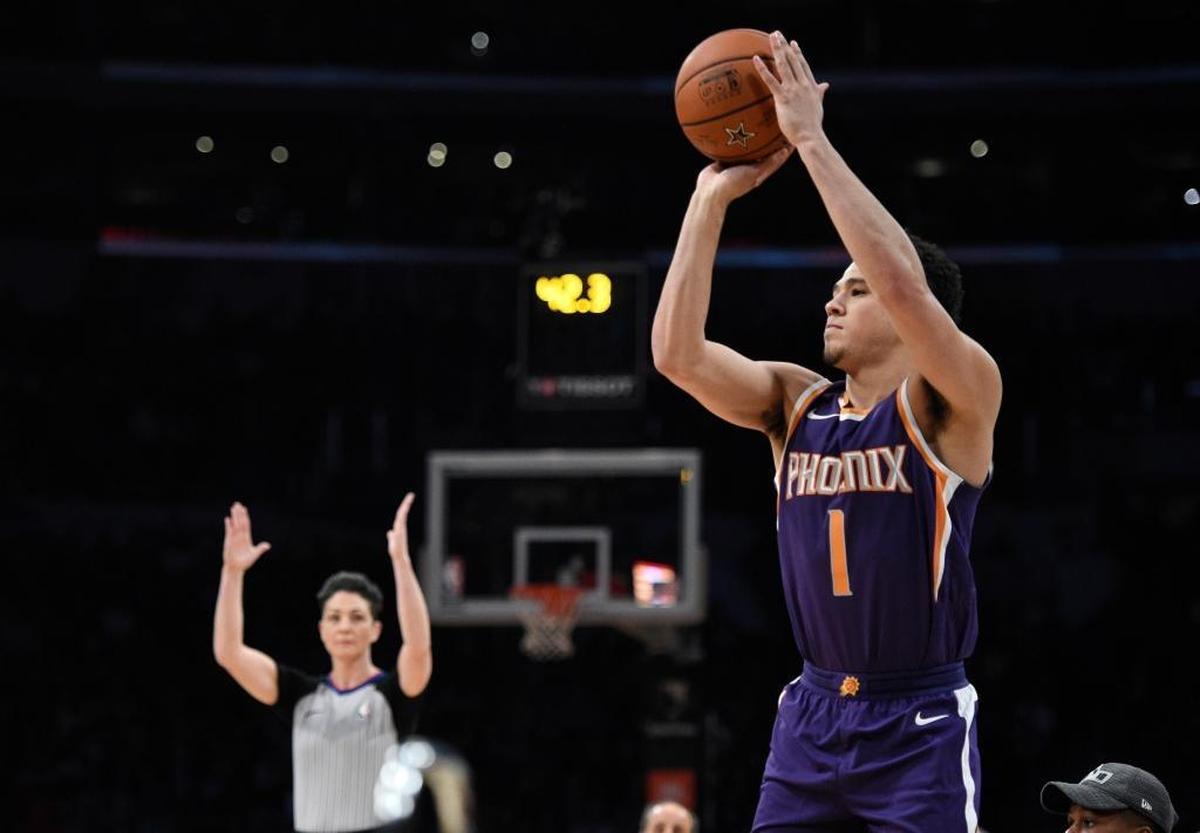 Phoenix Suns' Devin Booker shoots during the NBA basketball All-Star weekend 3-Point contest, Saturday, Feb. 17, 2018, in Los Angeles. Booker won the event.
