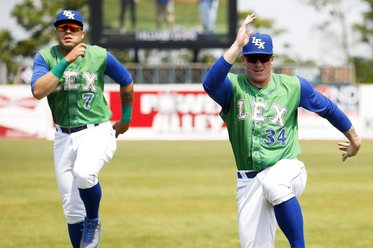 Lexington Legends first baseman Chris DeVito (34) warmed up with teammate Emmanuel Rivera before Wednesday’s home game against Greensboro. DeVito sat out Wednesday’s game and was later promoted to advanced-Class A Wilmington, N.C.