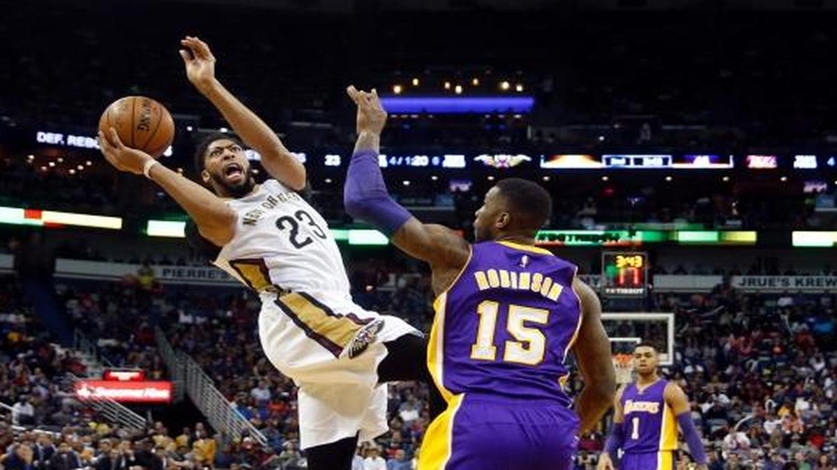 New Orleans Pelicans forward Anthony Davis (23) shoots against Los Angeles Lakers forward Thomas Robinson (15) in the first half of an NBA basketball game in New Orleans, Saturday, Nov. 12, 2016.