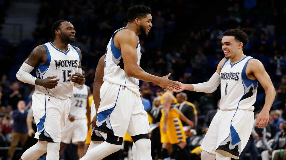 Minnesota Timberwolves teammates Karl-Anthony Towns, center, and Tyus Jones (1) celebrate their lead in the second half of an NBA basketball game Sunday, Jan. 22, 2017, in Minneapolis. The Wolves won 111-108.