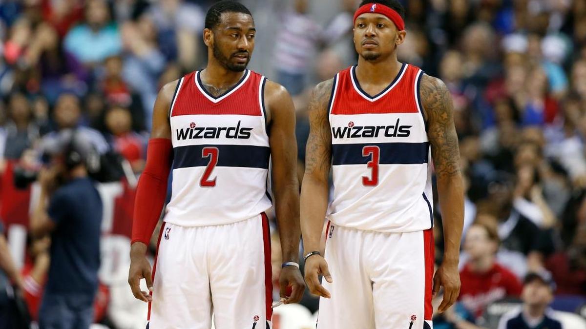 In this photo taken March 25, 2016, Washington Wizards guard John Wall (2) and Washington Wizards guard Bradley Beal (3) stand on the court during an NBA basketball game against the Minnesota Timberwolves, in Washington. With only one ball on the court at any given time, Wall and Beal know they have to share it. Wall and Beal have to share the ball on last-second shots and the limelight in the backcourt as the Washington Wizards are trying to get back to the playoffs. Wall is healthy again after having surgery on each knee, and Beal is fresh off signing a $128 million, five-year contract that ranked among the richest in the NBA this offseason. (AP Photo/Alex Brandon)