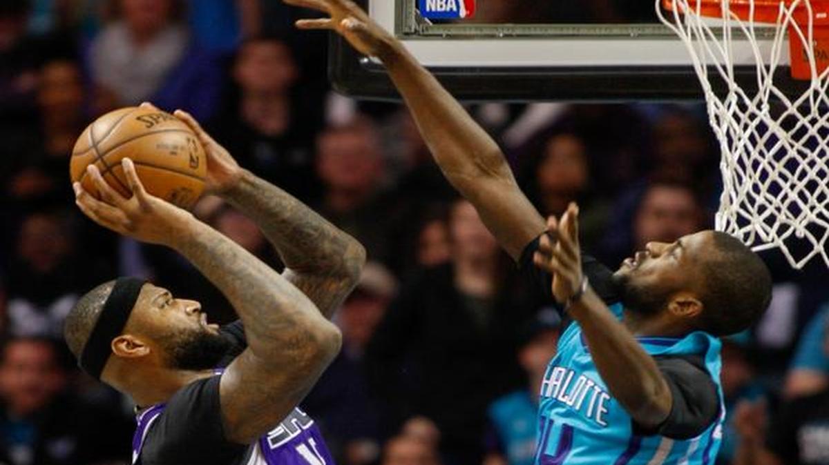 Sacramento Kings forward DeMarcus Cousins, left, shoots over Charlotte Hornets forward Michael Kidd-Gilchrist in the second half of an NBA basketball game in Charlotte, N.C., Saturday, Jan. 28, 2017. Sacramento won 109-106.