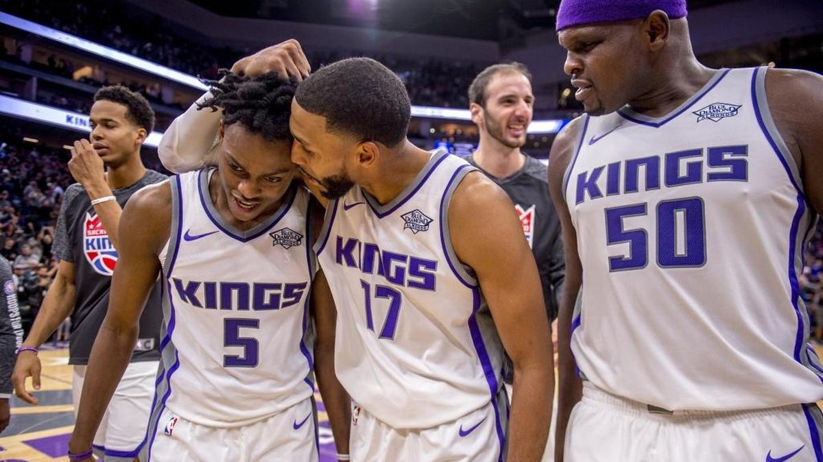Sacramento Kings guard De’Aaron Fox (5) is embraced by his teammate Garrett Temple (17) following the Kings 109-108 victory against the Philadelphia 76ers on Thursday, Nov. 9, 2017.