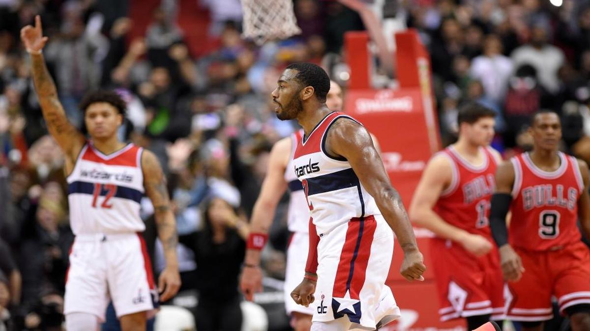 Washington Wizards guard John Wall (2) reacts after he scored during the closing seconds of an NBA basketball game against the Chicago Bulls, Tuesday, Jan. 10, 2017, in Washington. Also seen is Chicago Bulls guard Rajon Rondo (9) and Washington Wizards forward Kelly Oubre Jr. (12). The Wizards won 101-99.
