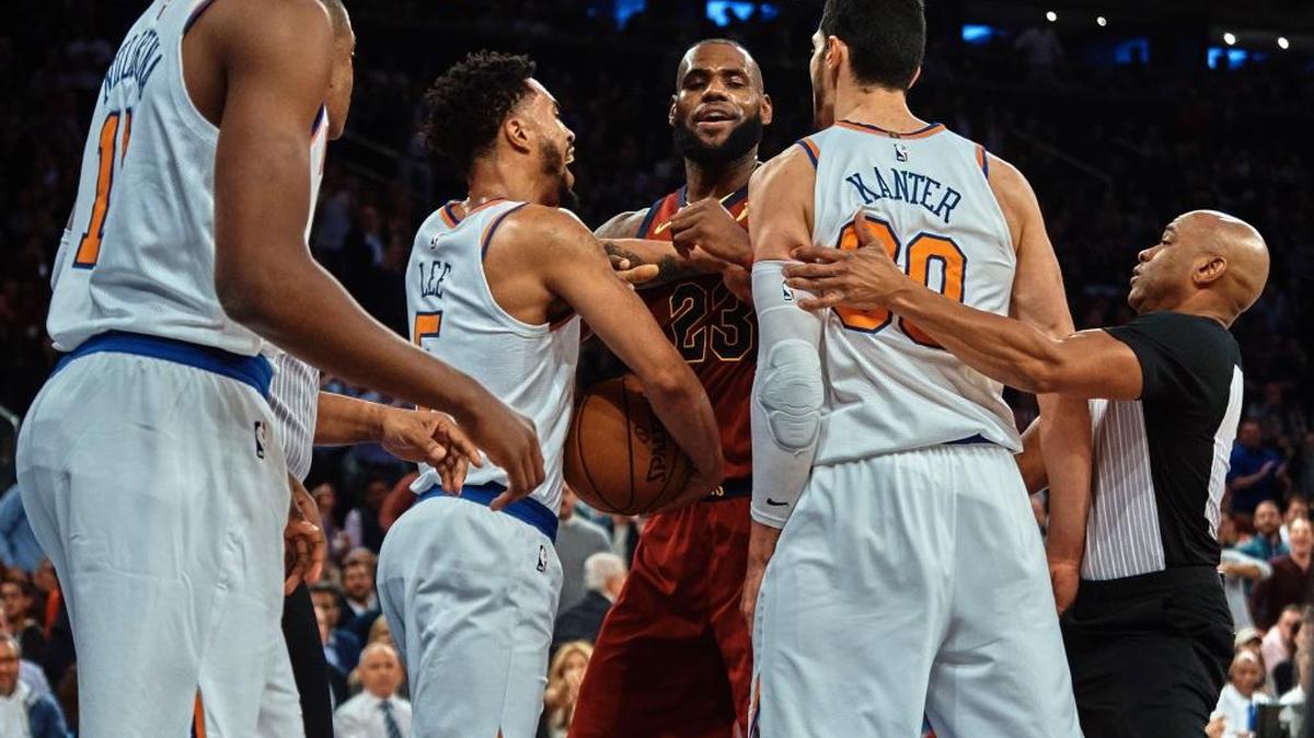 Cleveland Cavaliers' LeBron James, center, discusses with New York Knicks' Enes Kanter, center right, and Courtney Lee, center left, during the first half of a NBA basketball game at Madison Square Garden in New York, Monday, Nov. 13, 2017.