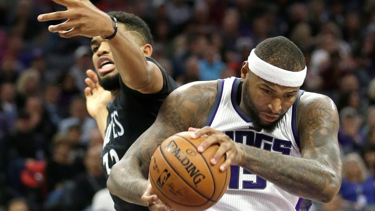 Sacramento Kings center DeMarcus Cousins , right, grabs a rebound from Minnesota Timberwolves forward Karl-Anthony Towns during the second quarter of an NBA basketball game in Sacramento, Calif., Saturday, Oct. 29, 2016.