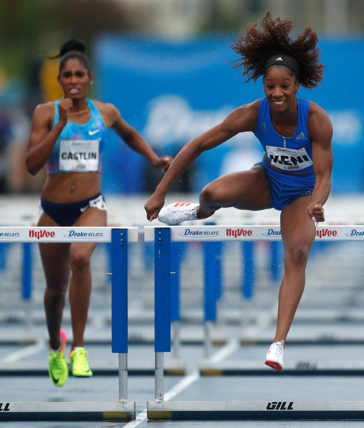 Kendra Harrison, right, clears the final hurdle ahead of Kristi Castlin, left, while winning the women's special 100-meter hurdles at the Drake Relays athletics meet, Saturday, April 29, 2017, in Des Moines, Iowa.