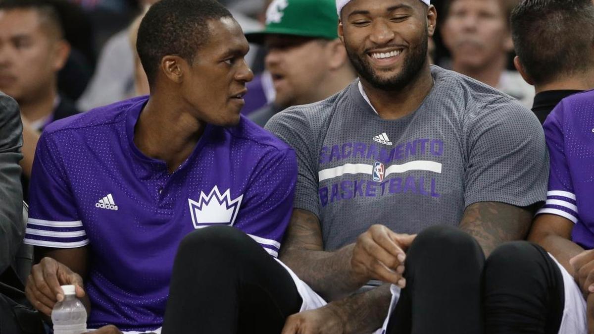 The Sacramento Kings’ Rajon Rondo, left and DeMarcus Cousins relaxed on the bench during the second half of a preseason game against the San Antonio Spurs on Oct. 8, 2015. The Kings won 95-92.