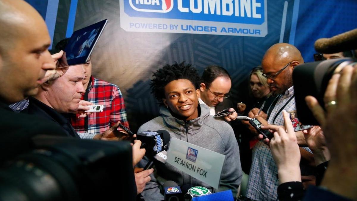 De'Aaron Fox, center, from Kentucky, listens to a question at the NBA draft basketball combine Friday, May 12, 2017, in Chicago.