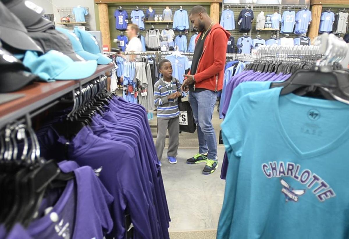 Charlotte Hornets forward Michael Kidd-Gilchrist helps Kyle Gadson, 9, shop at DICK’S Sporting Goods at Southpark. on Tuesday, December 5, 2017. Ten local kids from Partners for Parks received $100 DICK’S Sporting Goods gift cards and shopping help from Kidd-Gilchrist, as part of the event sponsored by DICK’S Sporting Goods.