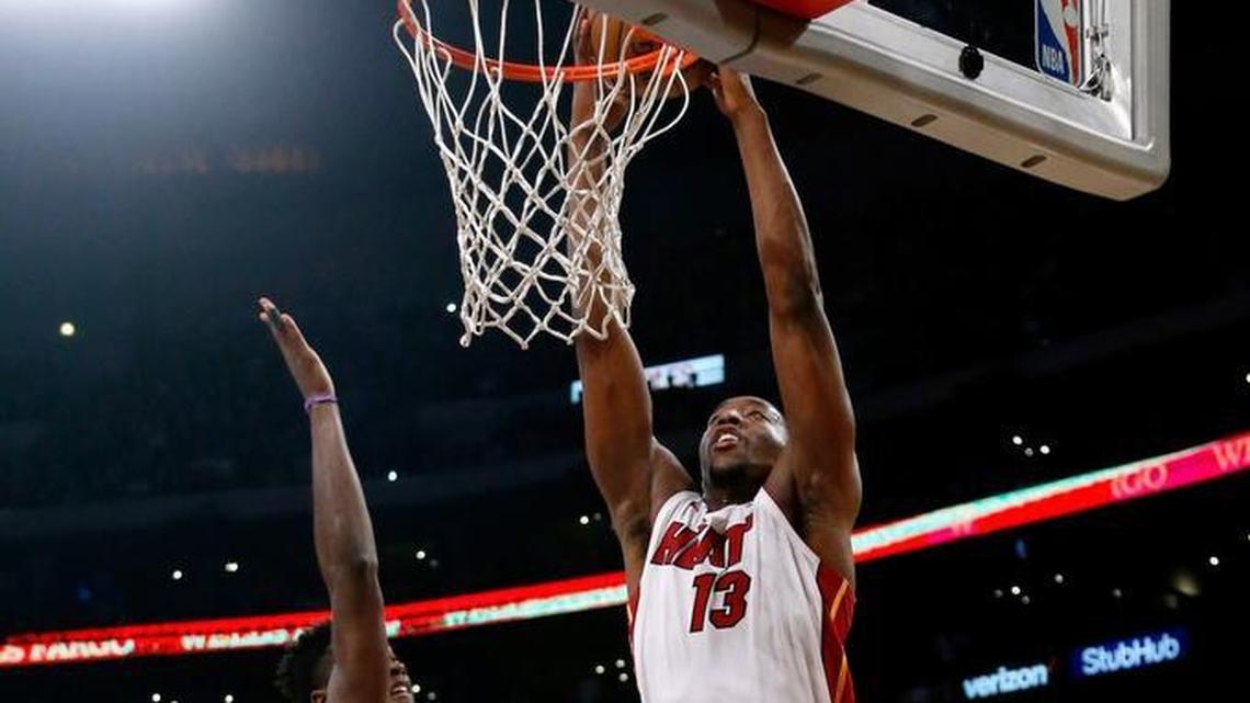 Heat center Bam Adebayo, right, went for a dunk against Lakers forward Julius Randle during the first half on March 16.