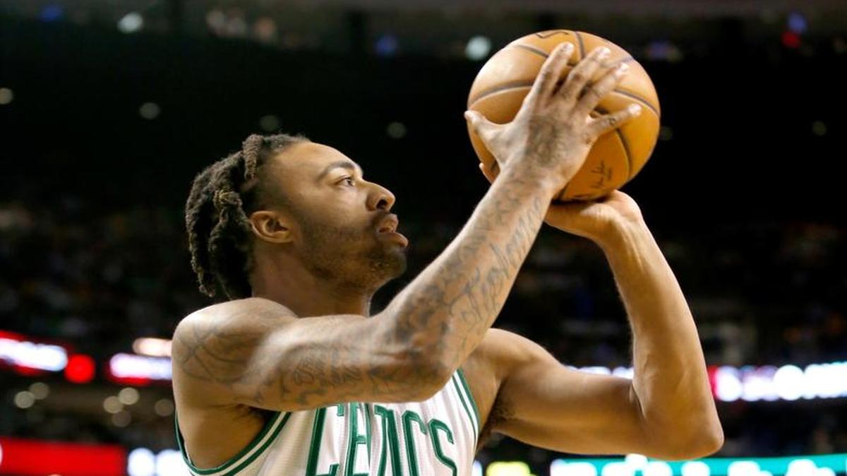 Boston Celtics guard James Young (13) shoots during the first half of an NBA basketball game against the Milwaukee Bucks, Wednesday, March 29, 2017, in Boston.