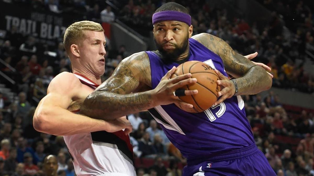 The Kings’ DeMarcus Cousins, right, drove to the basket on the Trail Blazers’ Mason Plumlee during the first half Tuesday night in Portland, Ore.