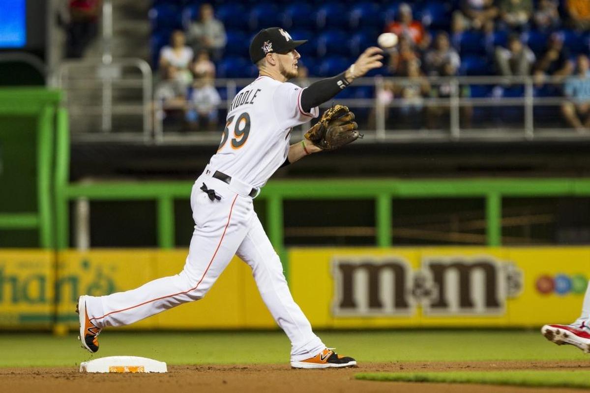 Marlins short stop JT Riddle turns a double play as the Miami Marlins play the Philadelphia Phillies at Marlins Park on Monday, July 17, 2017.