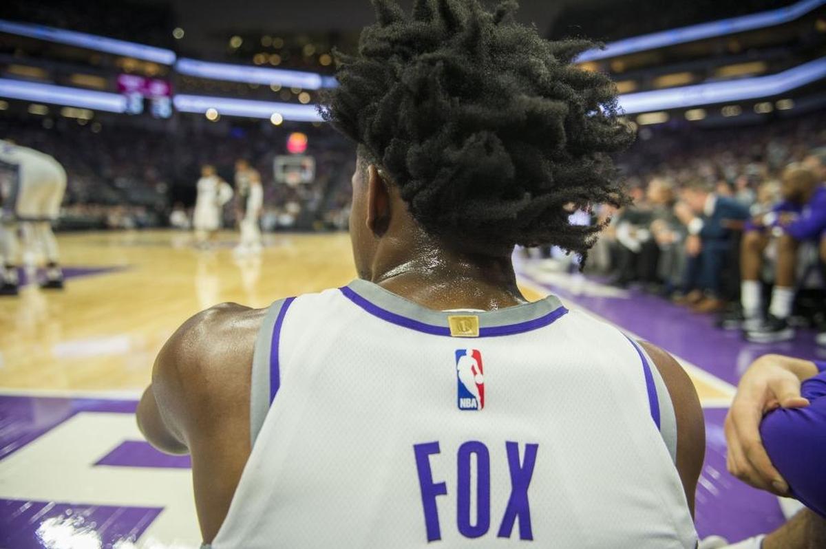 Sacramento Kings guard De’Aaron Fox (5) watches the game from the floor against the San Antonio Spurs in their preseason game on Monday, Oct. 2, 2017, at Golden 1 Center in Sacramento, Calif.