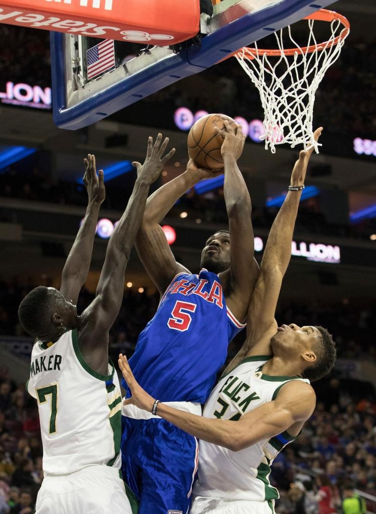 The Philadelphia 76ers’ Alex Poythress, center, goes up to shoot with Milwaukee Bucks’ Thon Maker, left, and Giannis Antetokounmpo, right, defending during the second half of an NBA basketball game, Saturday, April 8, 2017, in Philadelphia.