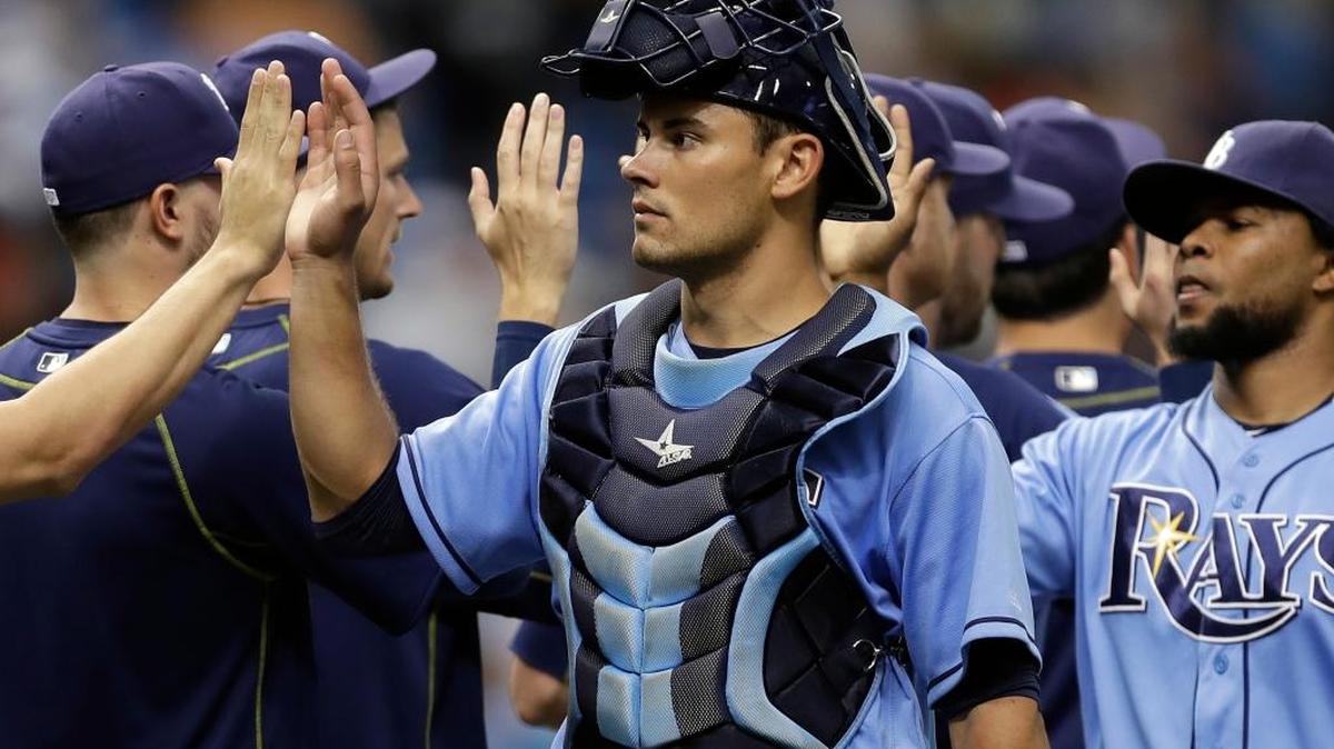 Tampa Bay Rays catcher Luke Maile high-fives teammates after they defeated the New York Yankees during a baseball game Sunday, July 31, 2016, in St. Petersburg, Fla.