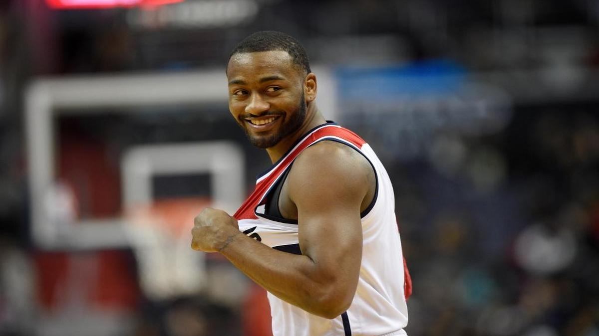 Washington Wizards guard John Wall (2) smiles during the first half of an NBA basketball game against the Milwaukee Bucks, Saturday, Dec. 10, 2016, in Washington.