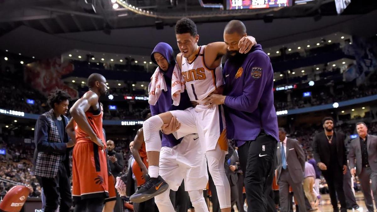 Phoenix Suns guard Devin Booker (1) is carried off by teammates during the second half of an NBA basketball game against the Toronto Raptors on Tuesday, Dec. 5, 2017, in Toronto.