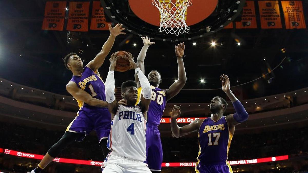 Philadelphia 76ers' Nerlens Noel (4) tries to shoot against Los Angeles Lakers' D'Angelo Russell (1), Julius Randle (30) and Roy Hibbert (17) during the first half of an NBA basketball game, Tuesday, Dec. 1, 2015, in Philadelphia. Philadelphia won 103-91.