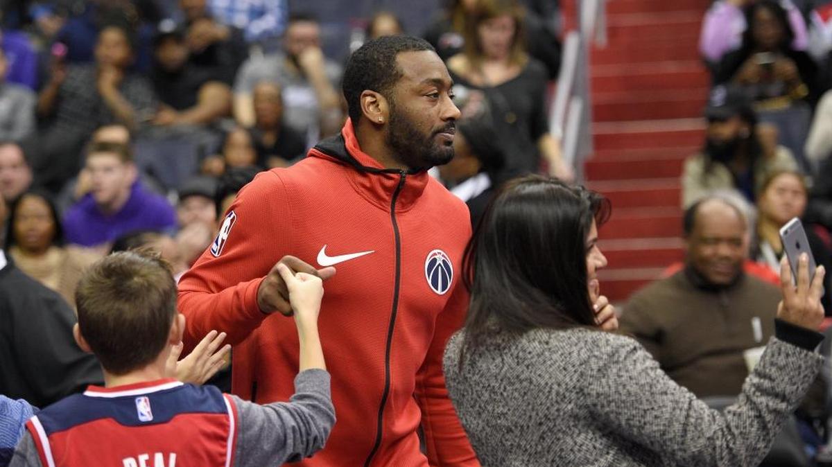 Washington Wizards guard John Wall fist bumps a fan during half time prior to the second half of an NBA basketball game against the Portland Trail Blazers, Saturday, Nov. 25, 2017, in Washington. Wall did not play due to injury. The Trail Blazers won 108-105.