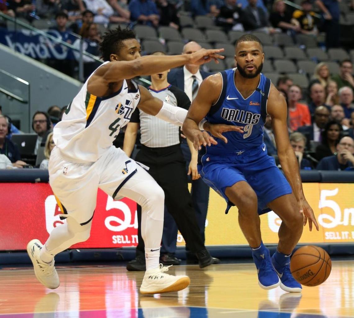 New Mavericks guard Aaron Harrison (9) was defended by Jazz guard Donovan Mitchell during the fourth quarter Thursday night in Dallas.