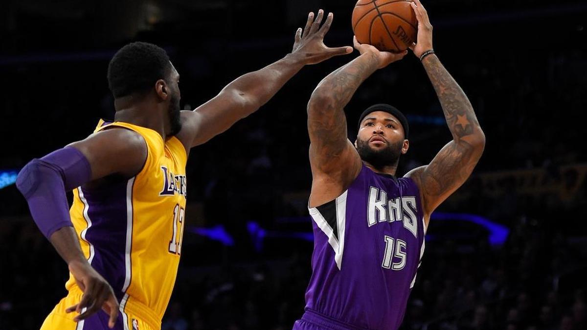 Sacramento Kings center DeMarcus Cousins, right, shoots as Los Angeles Lakers center Roy Hibbert defends during the first half of an NBA basketball game, Wednesday, Jan. 20, 2016, in Los Angeles.