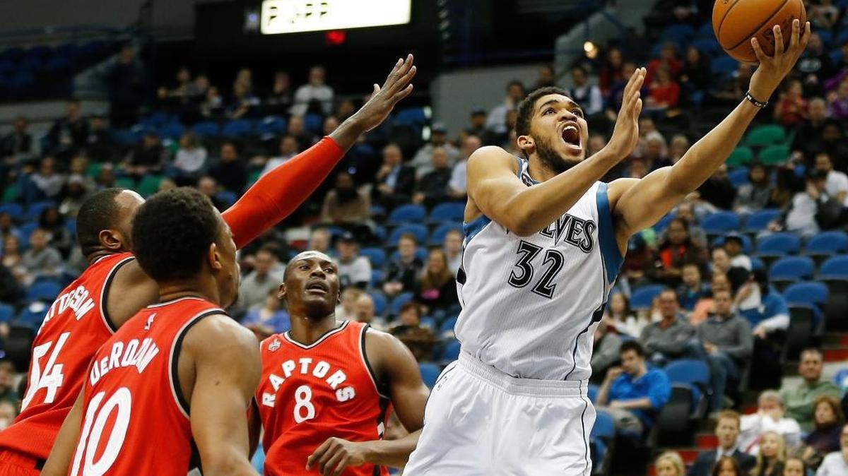 Timberwolves center Karl-Anthony Towns (32) sent up to the basket past the Raptors’ defense in the first half on Feb. 10 in Minneapolis.