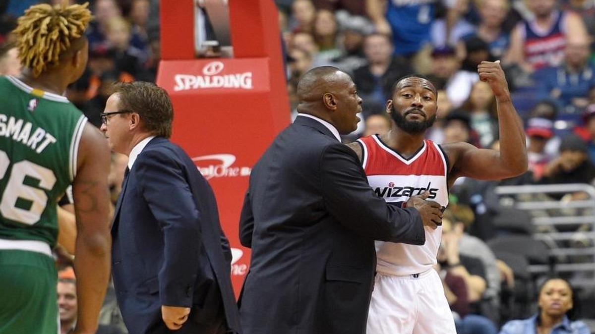 Washington Wizards guard John Wall, right, gestured toward Boston Celtics guard Marcus Smart during the second half Wednesday night. Wall, a former UK one-and-done star, was charged with a flagrant type-2 foul and was ejected. The Wizards won 118-93.