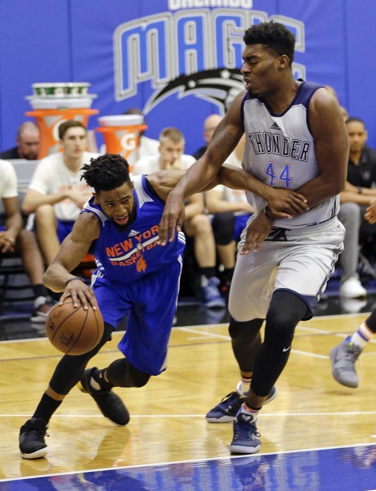 Dakari Johnson tried to slow down New York’s Chasson Randle during NBA Summer League play in Orlando on Monday.