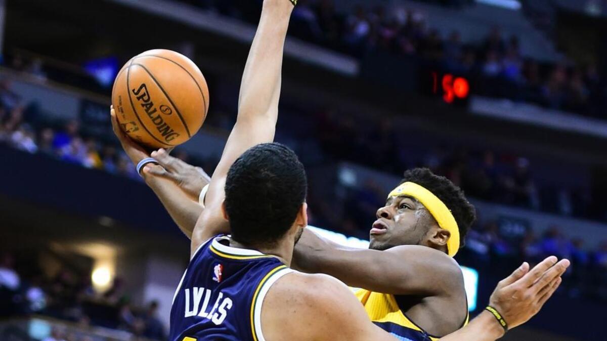 Jazz forward Trey Lyles tried to stop the Nuggets’ Emmanuel Mudiay in the first half in Denver on Sunday.