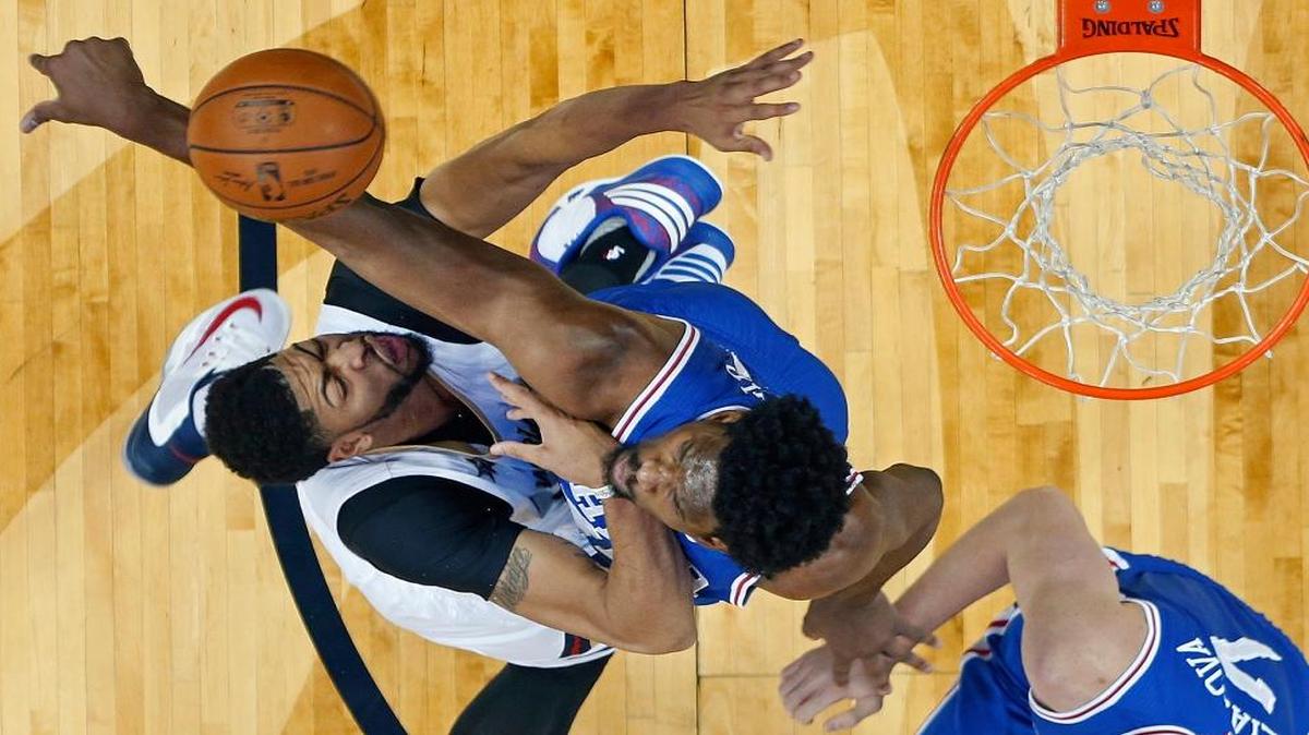 Philadelphia 76ers center Joel Embiid (21) blocks a shot by New Orleans Pelicans forward Anthony Davis in the first half of an NBA basketball game in New Orleans, Thursday, Dec. 8, 2016. 76ers forward Ersan Ilyasova (7) is at right.