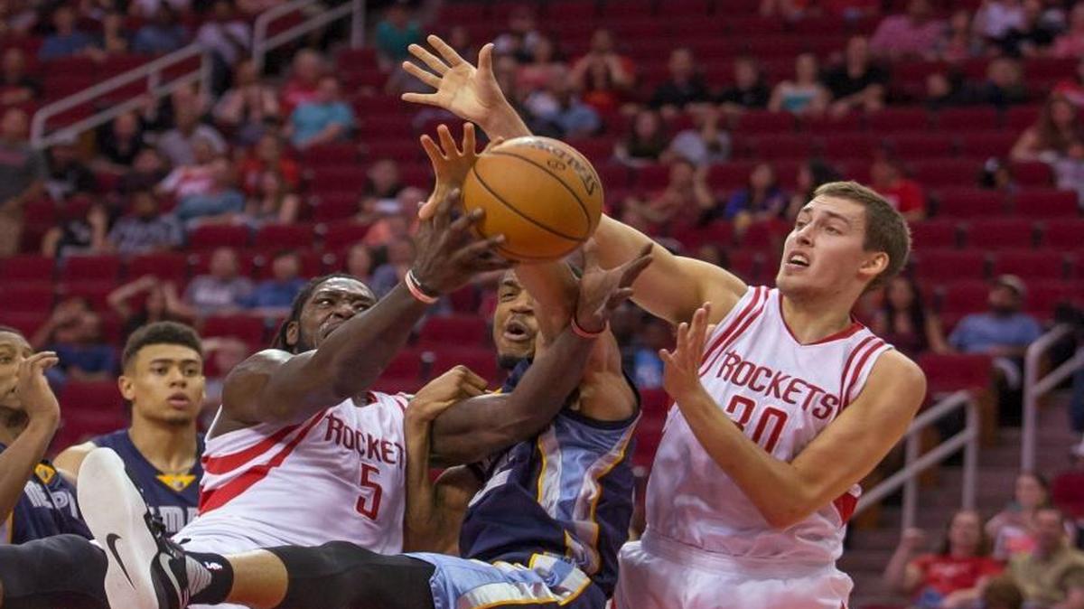 Houston Rockets forwards Montrezl Harrell and Kyle Wiltjer compete with Memphis Grizzlies forward Vince Hunter for a rebound during overtime of a preseason NBA basketball game Saturday, Oct. 15, 2016, in Houston.