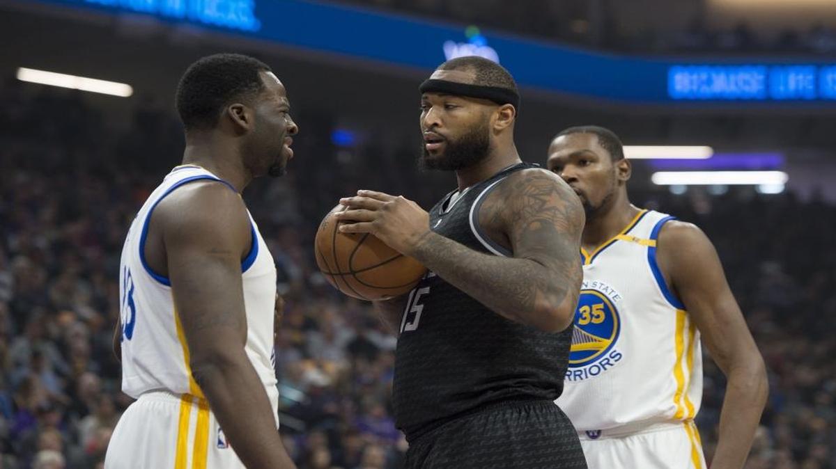 Sacramento Kings forward DeMarcus Cousins (15) and Golden State Warriors forward Draymond Green (23) after a foul call against Green during their game at Golden 1 Center in Sacramento, Calif., on Sunday, January 8, 2017.