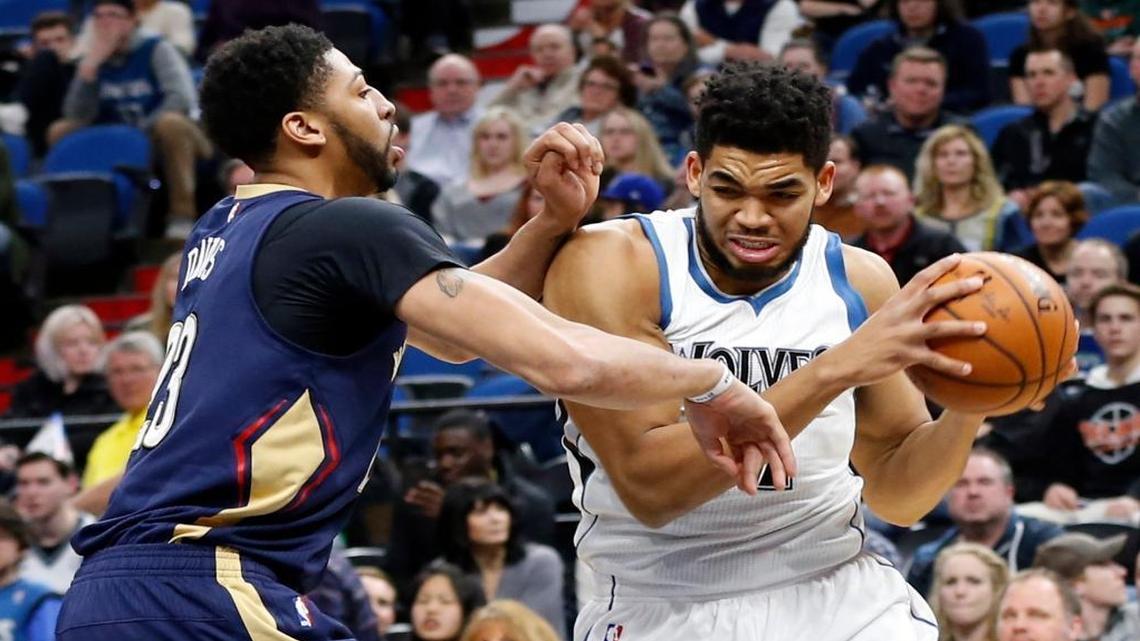 Minnesota Timberwolves' Karl-Anthony Towns, right, works around New Orleans Pelicans' Anthony Davis during the first quarter of an NBA basketball game Friday, Feb. 10, 2017, in Minneapolis.