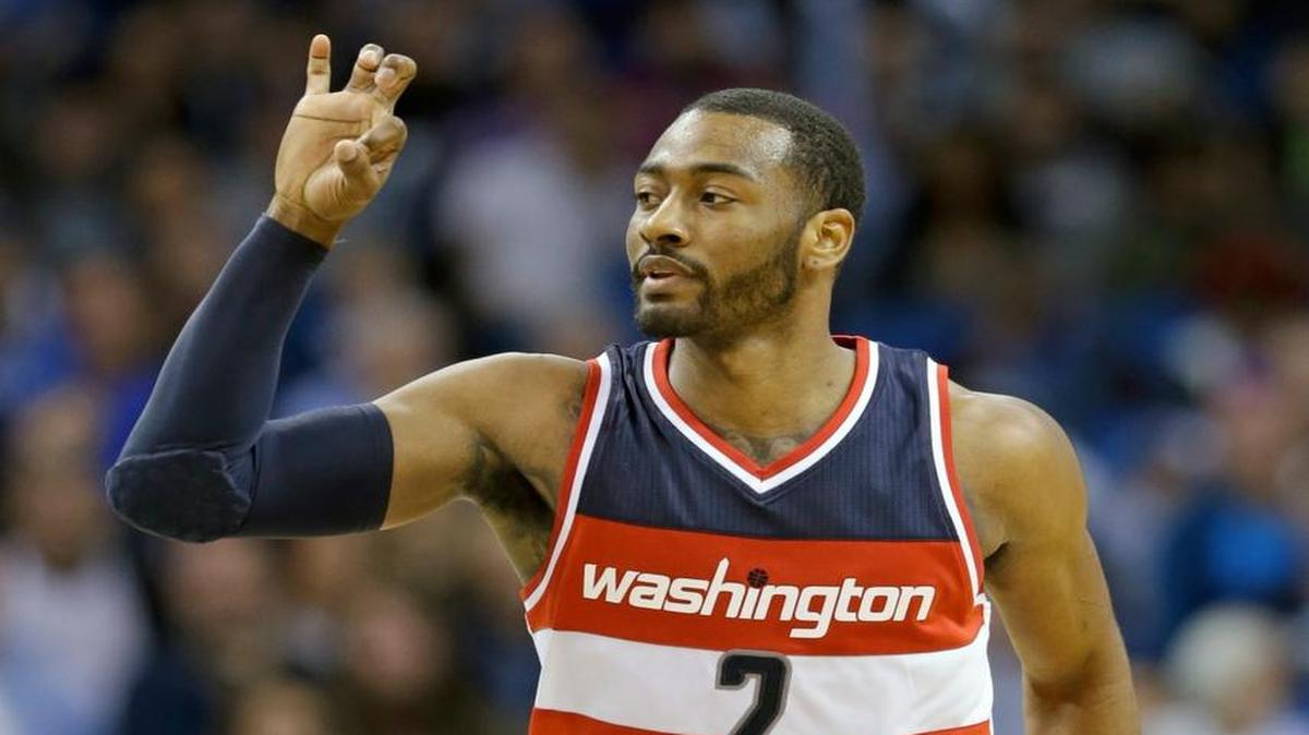 Washington Wizards' John Wall (2) waves there fingers after sinking a 3-point shot against the Orlando Magic during the second half of an NBA basketball game, Saturday, Jan. 9, 2016, in Orlando, Fla. Washington won 105-99.