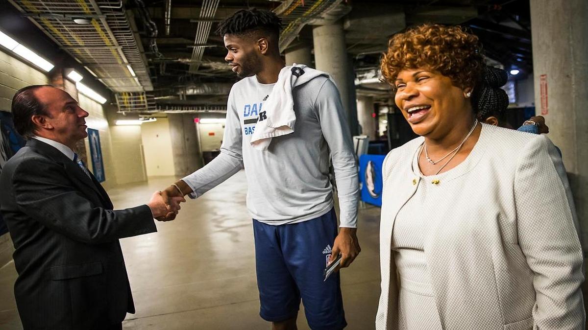 Dorcina Noel smiles as her son, Dallas Mavericks forward Nerlens Noel, chats with team COO Floyd Jahner in the tunnel before an NBA basketball game at American Airlines Center on Friday, March 10, 2017 in Dallas, Texas.