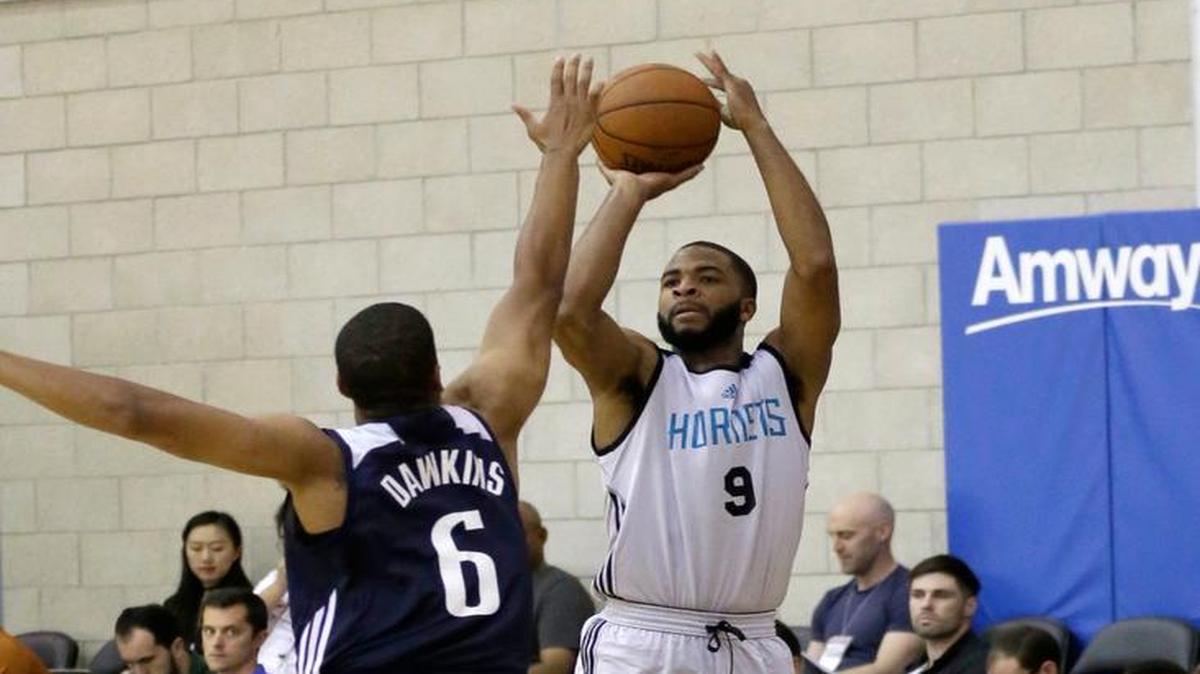 The Charlotte Hornets’ Aaron Harrison (9) took a shot over the Dallas Mavericks' Andre Dawkins (6) during an NBA summer league basketball in Orlando, Fla., on July 6, 2016.